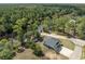 Drone's-eye view of a cozy residence nestled amidst the lush greenery and the calm waters of the lake at 100 Lure Ct., Conway, SC 29526