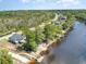 An aerial shot showcasing a home with waterfront access, surrounded by lush trees at 100 Lure Ct., Conway, SC 29526