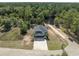 Aerial view of the property showcasing the house, driveway, and surrounding lush greenery at 100 Lure Ct., Conway, SC 29526