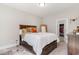 Well-lit bedroom with a large bed, wooden furniture, carpet flooring, and a walk-in closet at 100 Lure Ct., Conway, SC 29526