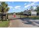 Gated community entrance showcasing the home in the distance and well-maintained surroundings at 100 Lure Ct., Conway, SC 29526