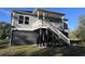 Exterior view of the home showing the elevated structure with staircase and the supporting beams at 100 Lure Ct., Conway, SC 29526