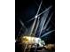 Night view of a raised home, illuminated by a bright interior and outdoor spotlights at 100 Lure Ct., Conway, SC 29526
