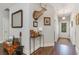 Entry hallway with hardwood floors, a decorative table and an unusual collection of artwork and curios at 100 Lure Ct., Conway, SC 29526