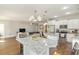 This open concept displays a bright kitchen, island with seating, with an open view to the living area at 100 Lure Ct., Conway, SC 29526