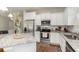 Bright open kitchen featuring white cabinets, stainless steel appliances, subway tile, and granite countertops at 100 Lure Ct., Conway, SC 29526