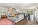 Spacious living room open to kitchen and dining area with hardwood floors, a neutral sectional and vintage rug at 100 Lure Ct., Conway, SC 29526