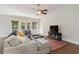 Comfortable living room featuring a sectional sofa, ceiling fan, large windows and access to an outdoor patio at 100 Lure Ct., Conway, SC 29526