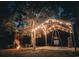 Covered outdoor space features lighting and a metal hanging pot, with a fire pit and benches nearby at 100 Lure Ct., Conway, SC 29526
