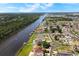 Aerial view showing a long waterway, houses along its banks, and lush greenery, offering a scenic perspective at 202 Ave. Of The Palms, Myrtle Beach, SC 29579