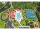 Overhead view of community amenities featuring a pool, tennis court, playground, beautiful landscaping and mature trees at 202 Ave. Of The Palms, Myrtle Beach, SC 29579
