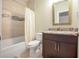Classic bathroom featuring a shower-tub combo and vanity with framed mirror at 202 Ave. Of The Palms, Myrtle Beach, SC 29579