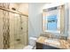 Well lit bathroom featuring a glass enclosed shower, vanity, and a decorative mirror at 202 Ave. Of The Palms, Myrtle Beach, SC 29579