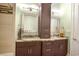Double vanity bathroom with decorative mirrors, granite countertops, and tiled shower at 202 Ave. Of The Palms, Myrtle Beach, SC 29579
