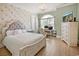 Charming bedroom features a decorative wallpaper, hard wood floors, and arched window with a chandelier at 202 Ave. Of The Palms, Myrtle Beach, SC 29579