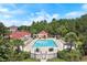Community pool area offers a pristine pool, lounge chairs, tables, and a charming clubhouse, surrounded by lush greenery at 202 Ave. Of The Palms, Myrtle Beach, SC 29579