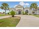 Beautiful home exterior features a circular driveway and lush tropical landscaping at 202 Ave. Of The Palms, Myrtle Beach, SC 29579