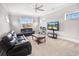 Comfortable living room with leather furniture, a large window, and a ceiling fan at 202 Ave. Of The Palms, Myrtle Beach, SC 29579
