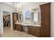 Bright main bathroom featuring double sinks, ample lighting, and walk-in closet at 202 Ave. Of The Palms, Myrtle Beach, SC 29579