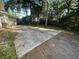 Concrete back patio, providing an outdoor space for relaxation and entertaining, surrounded by lush trees at 902 N 11Th Ave. N, North Myrtle Beach, SC 29582