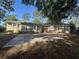 Backyard featuring a concrete patio with adjacent sunroom, offering a blend of indoor and outdoor living space at 902 N 11Th Ave. N, North Myrtle Beach, SC 29582
