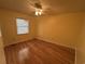 Bedroom with hardwood floors, yellow walls, a ceiling fan, and a window at 902 N 11Th Ave. N, North Myrtle Beach, SC 29582