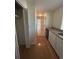 Hallway with hardwood floors and view to a bright room with tiled flooring at 902 N 11Th Ave. N, North Myrtle Beach, SC 29582