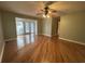 Spacious living room boasts hardwood floors, ceiling fan, and an open doorway leading to sunroom at 902 N 11Th Ave. N, North Myrtle Beach, SC 29582