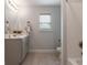 This bathroom features a neutral color scheme, with natural light and combination tub and shower at 2000 Easy St., Conway, SC 29526