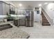 Well-lit kitchen features stainless steel appliances, granite countertops, and access to the staircase at 2000 Easy St., Conway, SC 29526