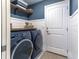 Laundry room featuring side-by-side washer and dryer units, shelving, and storage space at 2000 Easy St., Conway, SC 29526