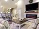 This staged living room has a ceiling fan, a fireplace, and a view of the kitchen at 2000 Easy St., Conway, SC 29526