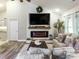 This staged living room showcases its electric fireplace, mantle, and furniture at 2000 Easy St., Conway, SC 29526