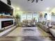 This staged living room has hardwood floors, two sofas, and an electric fireplace at 2000 Easy St., Conway, SC 29526