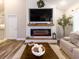 This staged living room features a modern electric fireplace with adjacent kitchen and access to the upstairs at 2000 Easy St., Conway, SC 29526