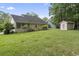 Spacious backyard with a shed, a sunroom, and lush green grass at 251 Galapagos Dr., Little River, SC 29566