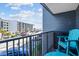 Balcony view of building parking lot, showing a blue outdoor chair and storage container at 5905 S Kings Hwy. # 231, Myrtle Beach, SC 29577