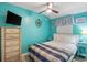Inviting bedroom with calming blue walls, ceiling fan, and a comfortable queen bed at 5905 S Kings Hwy. # 231, Myrtle Beach, SC 29577