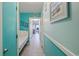 Hallway with blue walls, a bed, and a view of the living room with a blue chair at 5905 S Kings Hwy. # 231, Myrtle Beach, SC 29577