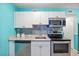 Well-equipped kitchen with stainless steel appliances, white cabinetry, and a tiled backsplash at 5905 S Kings Hwy. # 231, Myrtle Beach, SC 29577