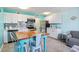 Bright kitchen features white cabinets, stainless steel appliances, and a dining table at 5905 S Kings Hwy. # 231, Myrtle Beach, SC 29577