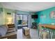 Cozy living room with a couch, dining table, and a view of the balcony at 5905 S Kings Hwy. # 231, Myrtle Beach, SC 29577