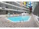 Refreshing outdoor swimming pool surrounded by a brick patio and vibrant colored banners at 5905 S Kings Hwy. # 231, Myrtle Beach, SC 29577