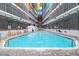 Outdoor swimming pool surrounded by colorful banners and a brick patio, perfect for relaxation at 5905 S Kings Hwy. # 231, Myrtle Beach, SC 29577