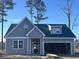 Charming gray home featuring a two-car garage and a welcoming front porch at 116 Infinity Ln., Loris, SC 29569