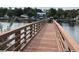 Exterior view of a dock extending over a waterway with waterfront homes at 674 Riverwalk Dr. # 301, Myrtle Beach, SC 29579