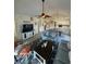 Bright open concept living area with vaulted ceilings, ceiling fan, tv and view to kitchen at 674 Riverwalk Dr. # 301, Myrtle Beach, SC 29579