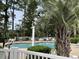 Inviting community pool area with ample seating and lush landscaping at 674 Riverwalk Dr. # 301, Myrtle Beach, SC 29579