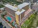 Aerial view of a resort featuring a pool, splashpad, manicured landscaping, and ocean views at 6900 N Ocean Blvd. # 405, Myrtle Beach, SC 29572
