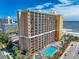 Stunning aerial view of the beachfront high-rise featuring multiple balconies and a pool area at 6900 N Ocean Blvd. # 405, Myrtle Beach, SC 29572